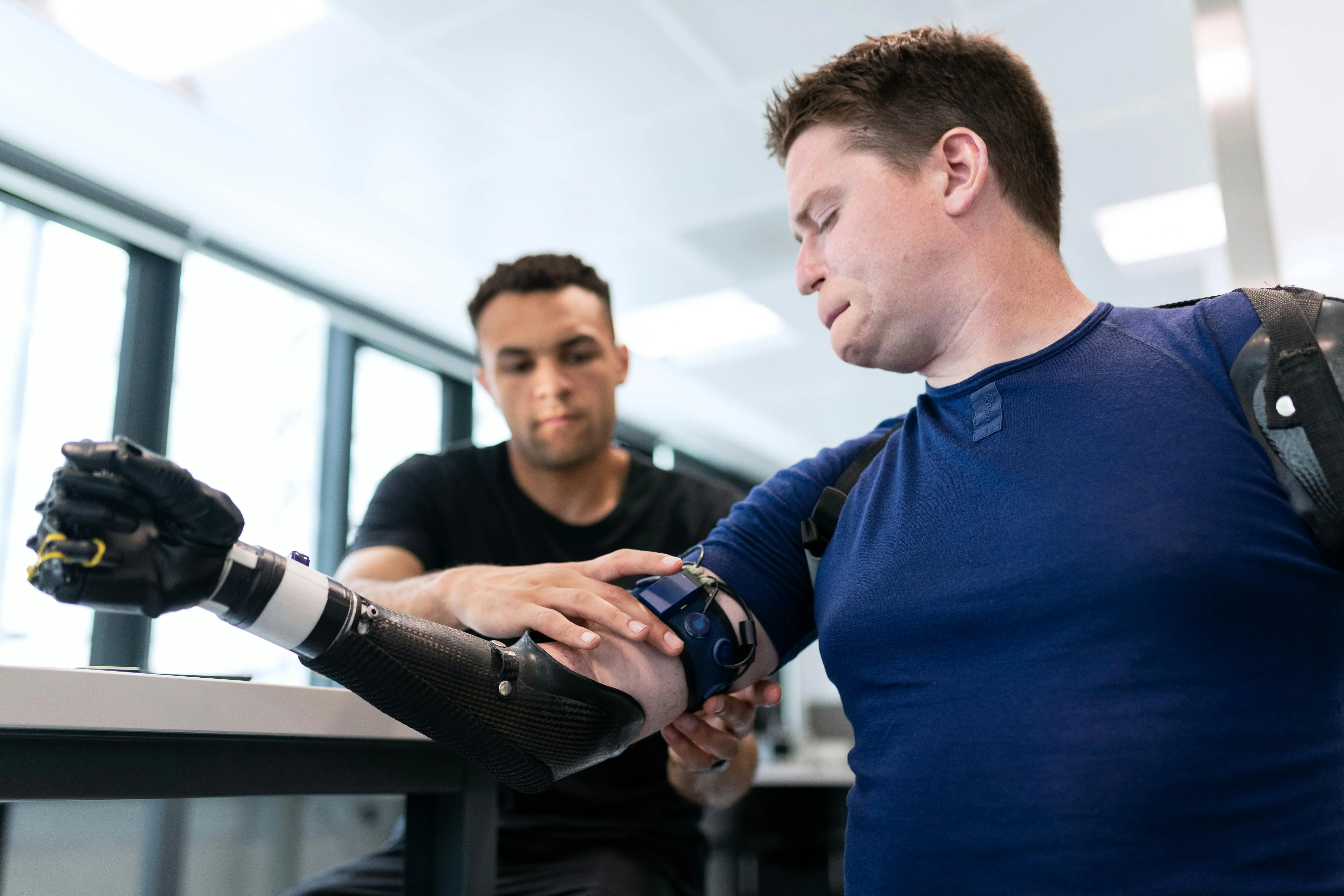 Engineer calibrating a bionic arm medical device.
